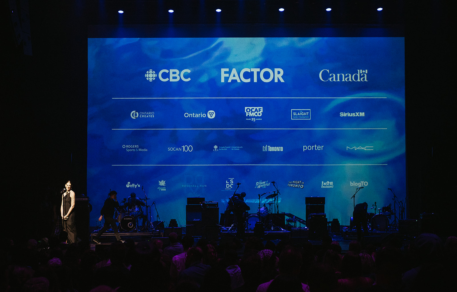 Executive Director Amber Still on Stage at Massey Hall for the 2025 Concert & Award Ceremony - Photo by Wade Muir